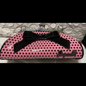 Sourpuss pink with black polka dot purse and a big black bow.
